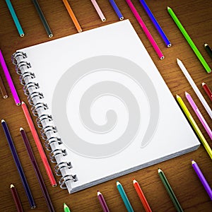 Blank notepad and colorful pencil