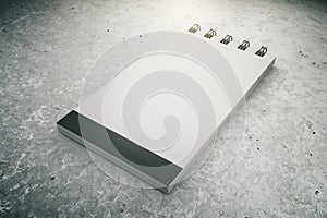 Blank notepad on concrete floor, 3D Render