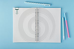 Blank notepad page in bullet journal on bright blue office desktop photo