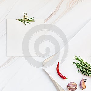 Blank notepad pages with greens herbs and spices