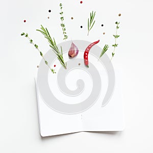 Blank notepad pages with greens herbs and spices