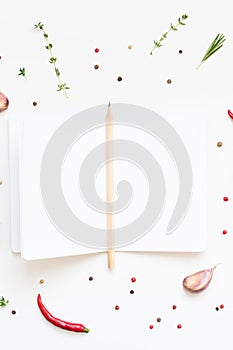 Blank notepad pages with greens herbs and spices