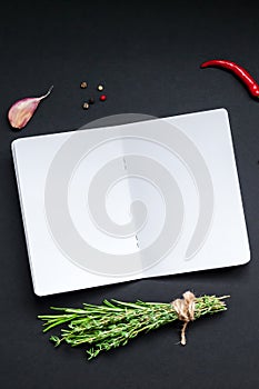 Blank notepad pages with greens herbs and spices