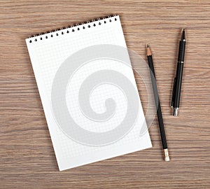 Blank notepad with pen and pencil