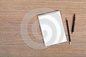 Blank notepad with pen and pencil