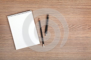 Blank notepad with pen and pencil