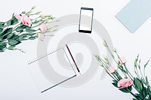 Blank notepad with pencil near mobile phone