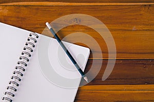 Blank notepad with pencil on office wooden table