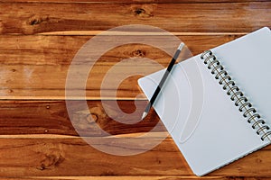 Blank notepad with pencil on office wooden table