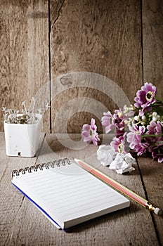 Blank notepad with pencil on wooden table