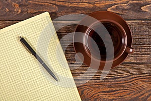 Blank notepad on a wooden table