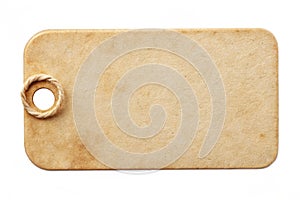 Blank old paper label or cloth tag with round corners isolated on white