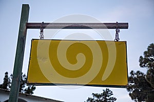 Blank Old Weathered Road Name Signage Hanging from Rusty Chain and Metal Rod Horizontally. Closeup Angle Shot of