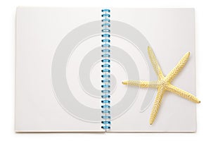 Blank open notepad with sea star