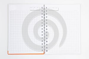 Blank and open white spiral notebook with an orange cover, with copy space