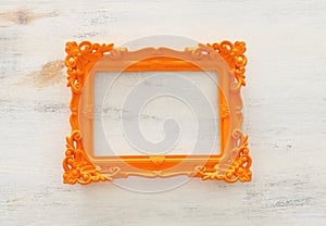 Blank orange photo frame over white background. Ready for photography montage. top view flat lay