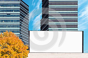 Blank outdoor billboard mockup with modern business buildings