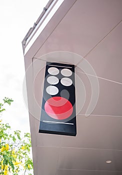 Blank outdoor sign hanging from white ceiling in front of shop or restaurant