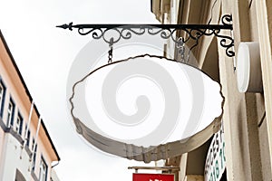 Blank Oval Signage hanging from wrought iron bracket