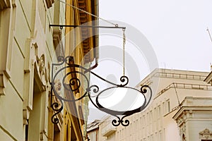 Blank Oval signboard, hanging from wrought iron bracket