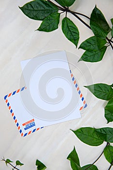 Blank paper card top view. Air Mail envelope with inscription in French Spanish. Clean table flat lay composition