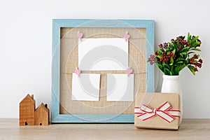 Blank paper cards hanging on blue vintage wooden frame and gift