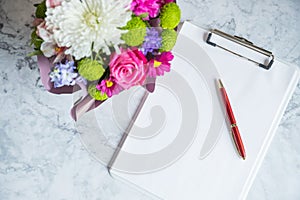 blank paper clipboard,pen, daisy and roses bouquet. Elegant, Beauty blog composition.Valentine's Day,Mother's