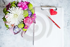 blank paper clipboard,pen, daisy and roses bouquet. Elegant, Beauty blog composition.Valentine's Day,Mother's