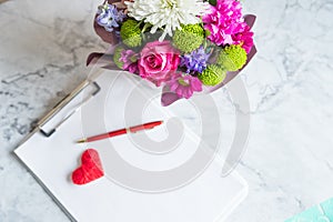 blank paper clipboard,pen, daisy and roses bouquet. Elegant, Beauty blog composition.Valentine's Day,Mother's