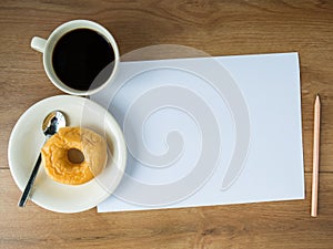 Blank paper with coffee cup and pencil and donut