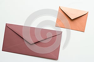 Blank paper envelopes on marble flatlay background, holiday mail letter or post card message design