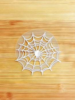Blank paper features spider webs that have been cut out incompletely photo