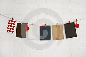 Blank paper frames on white brick wall