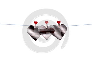Blank paper heart shape hang on three red wood clothes clip  and white string line patterns isolated on white background ,