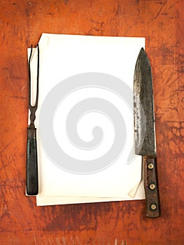 Blank paper menu with knife and fork as background