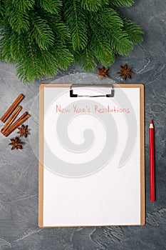 Blank paper with new year`s resolutions title. Flat lay. Top view. New year concept. Target success concept.