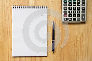 Blank paper note book with pen, calculator