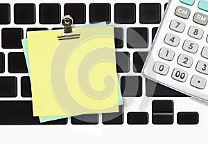 Blank paper note with metal clip on computer