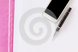 Blank paper note with pen on business file folder and cellphone