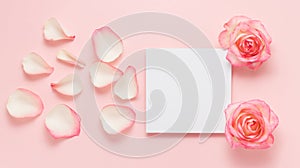 Blank paper note with roses and petals on pink background