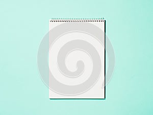 Blank paper notebook on blue background