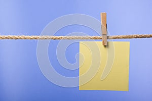 Blank paper notes hanging on rope with clothes pins, copy space