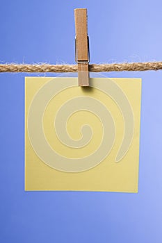 Blank paper notes hanging on rope with clothes pins, copy space