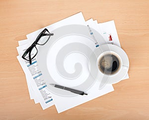 Blank paper with pen, glasses and coffee cup