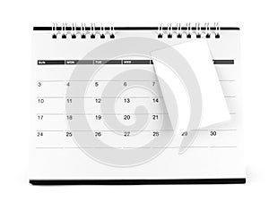 Blank paper sticky note attaching on desk calendar page with days and date isolated on white background