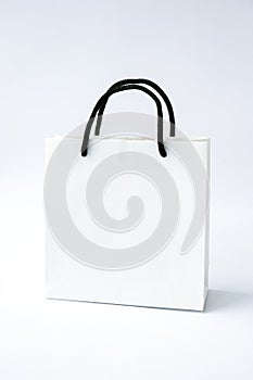 Blank paper white bag on white background. Black friday sale. Shopping concept. Mockup of paper shopping bag