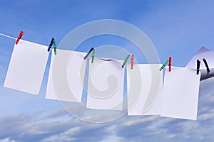 Blank papers on a clothesline