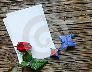 Blank papers on table with rose and gift