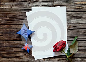 Blank papers on table with rose and gift