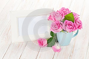 Blank photo frame and pink roses